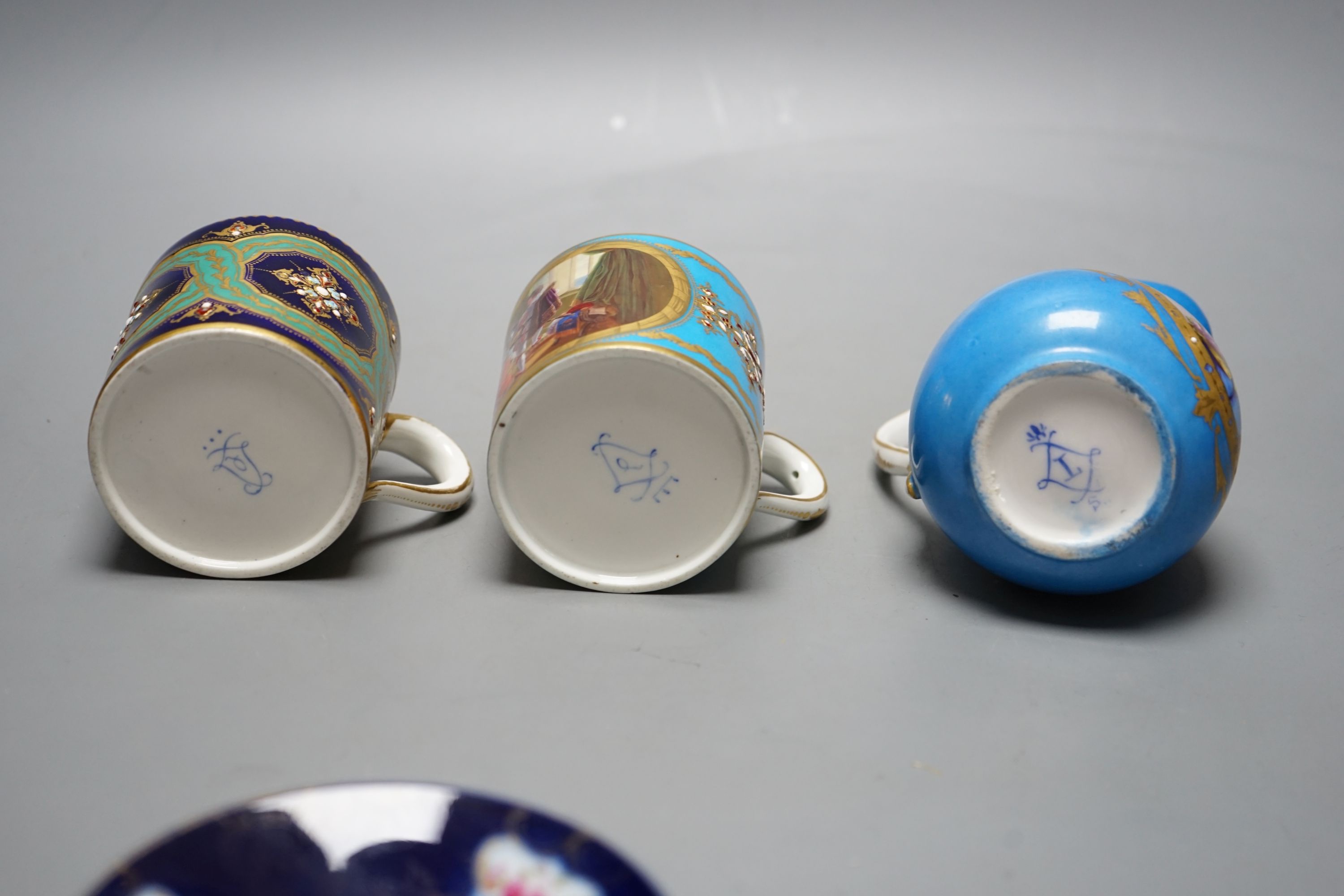 Two Sevres style porcelain coffee cans, cream jug and a cup and saucer, tallest ug 10 cms high.
